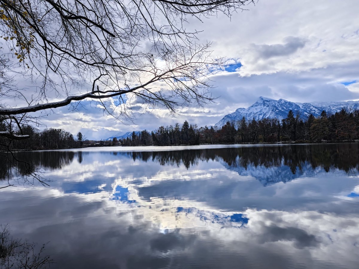 Mountains and clouds reflected in the lake by Schloss Leopoldskron, photographed during the 2023 Sonophilia Annual Meeting.