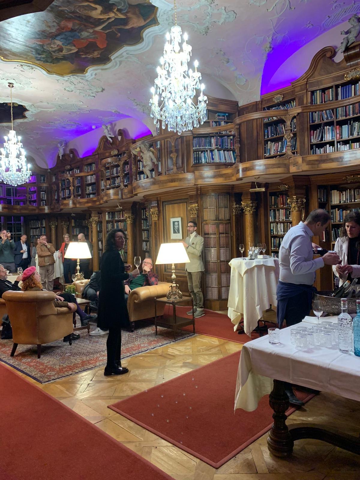 Sonophilia participants spending time together in the library at Schloss Leopoldskron in 2023.